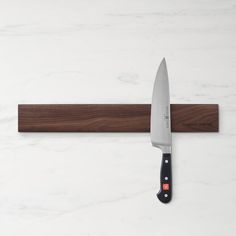 a large knife on top of a cutting board