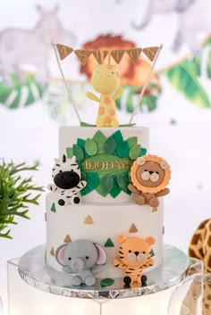 a birthday cake decorated with animals and decorations