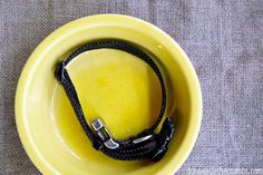 a yellow bowl with a black cord in it on a gray tablecloth and grey cloth