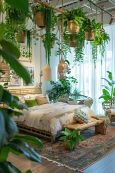 a bedroom with lots of plants hanging from the ceiling and bed in front of it