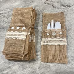 two burlap placemats with forks and spoons on them are sitting next to each other