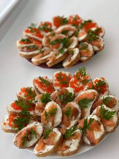 small appetizers are arranged on plates with garnishes and parsley