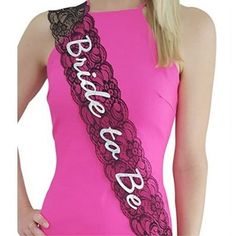 a woman wearing a pink and black sash with the word dance on it's side