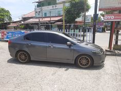 a small gray car parked on the street