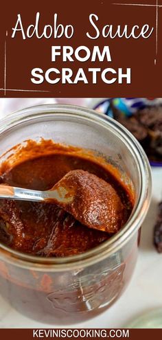 a jar filled with red sauce sitting on top of a table