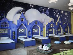 there are many beds in the room with stars on the wall and clouds painted on the walls