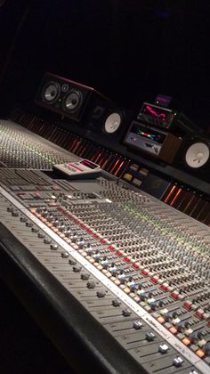 an audio mixing console in a recording studio