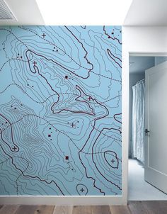 a blue wall with a map drawn on it in the hallway next to a white door