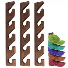 three wooden racks with different colored leaves on them and one is made out of wood