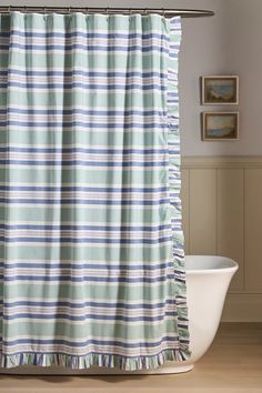 a blue and white striped shower curtain in a bathroom