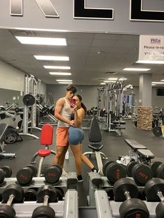 a man and woman are in the gym