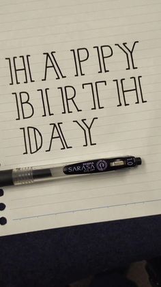 a notepad with writing on it that says happy birth day and an ink pen