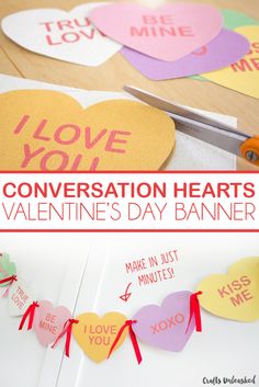 valentine's day banner with conversation hearts cut out and tied to the side on a table