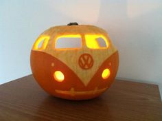 a carved pumpkin shaped like a vw bus with lights on it's side