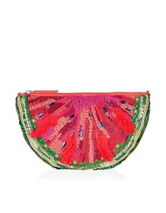 a pink and green clutch bag with sequins on the front, sitting on top of a white surface