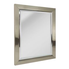 a silver framed mirror on a white wall