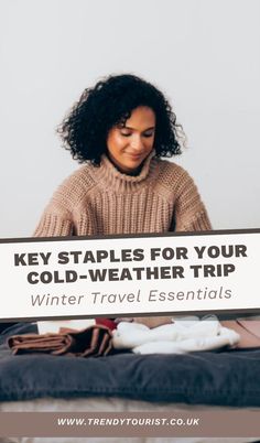 a woman sitting on top of a bed next to a sign that says, key staples for your cold - weather trip winter travel essentials