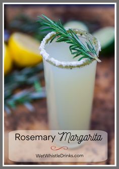 rosemary margarita in a tall glass on a wooden table