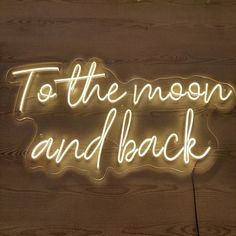 a neon sign that says to the moon and back