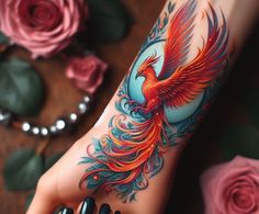 a woman's arm with a colorful bird tattoo on it and roses in the background