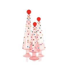 three pink vases with colorful dots and red balls on the top one is filled with confetti