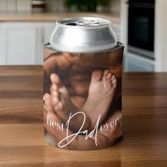 a can cooler with a baby's feet on it