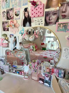 a vanity with a mirror and many pictures on the wall