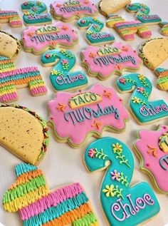 decorated cookies are arranged in the shape of numbers and letters on a white tablecloth