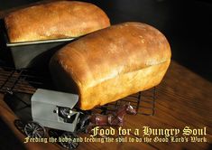 two loafs of bread sitting on top of a table next to a toy train