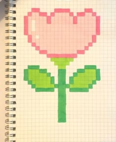 a drawing of a pink flower on top of a white notebook with the words pixel art written in it