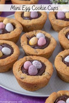 chocolate chip cookies with candy eggs in the middle on a plate, ready to be eaten