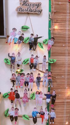 a group of children are hanging on the wall with happy birthday signs attached to them