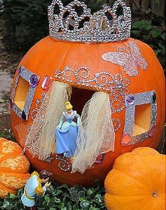 a pumpkin decorated with princesses and other decorations