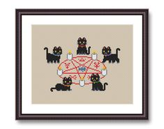 a cross stitch pattern with black cats and a red tablecloth in the shape of an umbrella