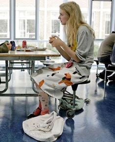 two people sitting at a table eating food