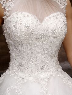 the back of a wedding dress with flowers on it