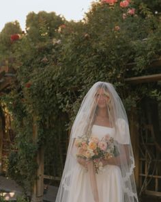 a woman in a wedding dress holding a bouquet