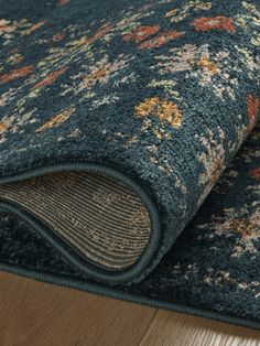 a blue rug with floral designs on it