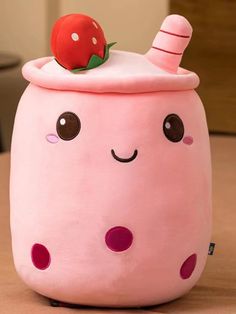 a pink stuffed animal with a strawberry on top