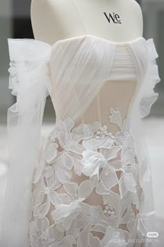 the back of a white wedding dress on display