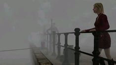 a woman is standing on a railing in the fog