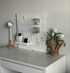 a white desk with some flowers on it