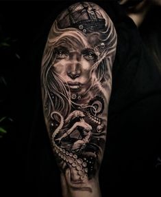 a woman's arm with an octopus and ship tattoo on the left side of her arm