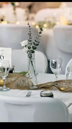 the table is set with silverware and flowers