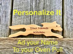 a personalized wooden sign with an image of a dog on it and the words, your name to your oven pull