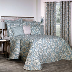 a blue and white comforter set with matching pillows