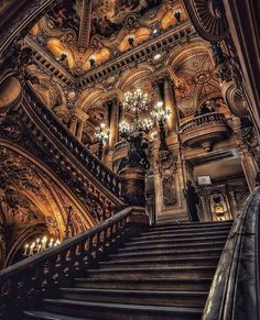 an ornate staircase with chandeliers and lights