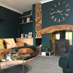 a living room filled with furniture and a large clock mounted to the wall above it