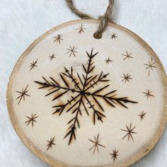 a wooden ornament with an image of a snowflake in the center