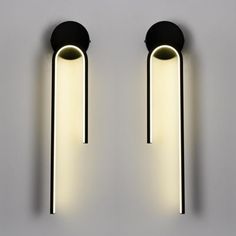 two lights that are on the wall next to each other, one is black and white